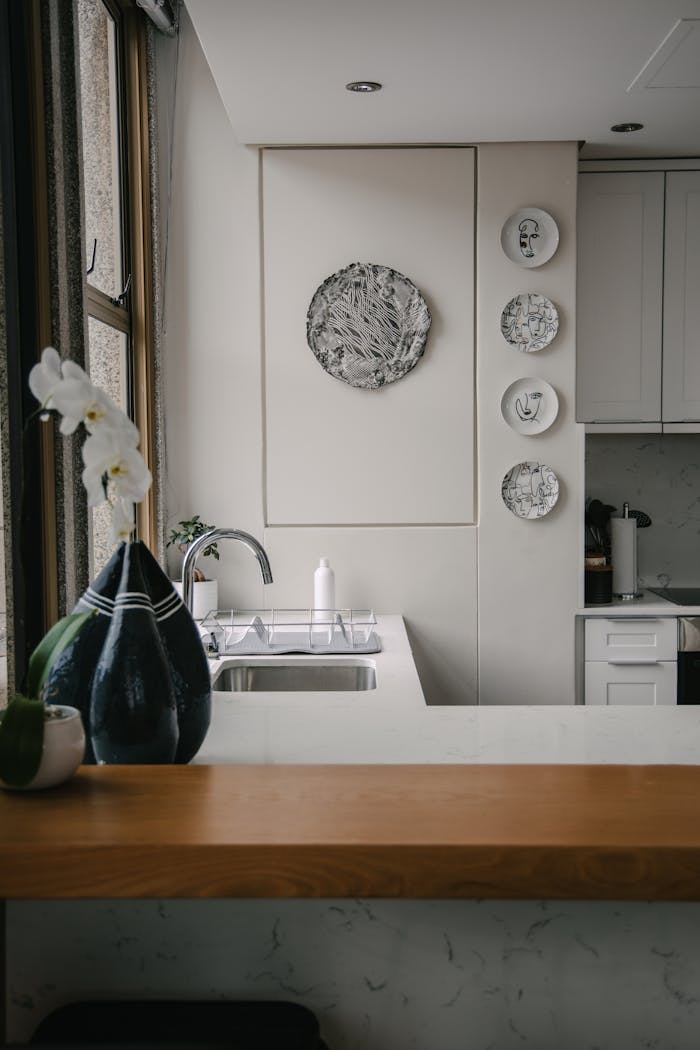 our-story Elegant minimalistic kitchen interior featuring a contemporary design with decorative elements and natural light.